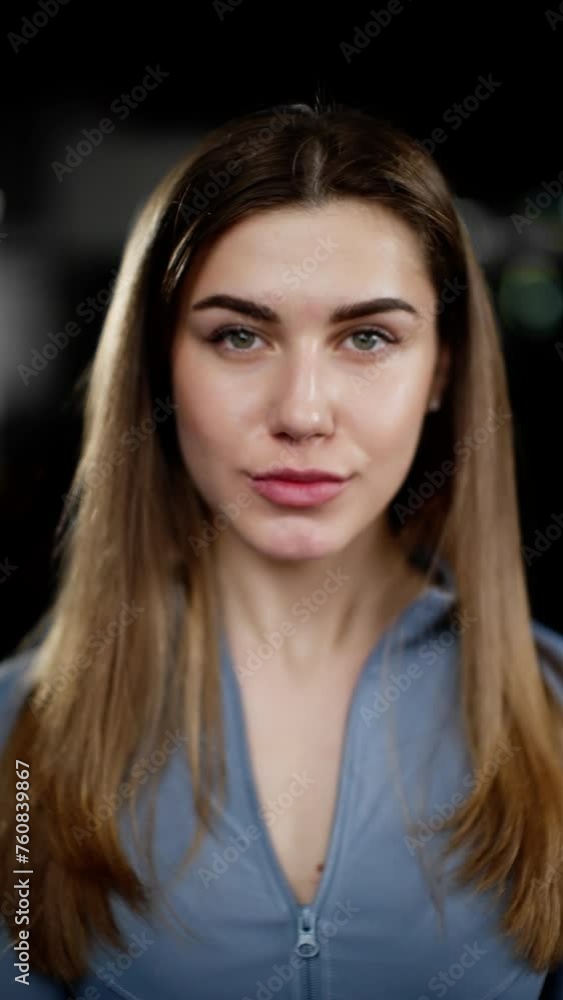 Close-up portrait of a young athletic woman in sportswear, poised and confident in the gym Close-up portrait of a young athletic woman in sportswear, poised and confident in the gym