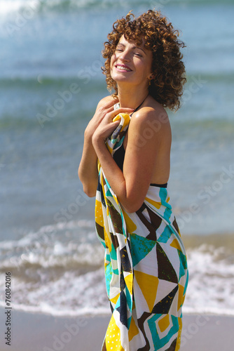 Happy woman with hand on chest on shore