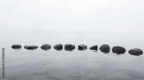 a group of rocks sitting in the middle of a body of water on top of a body of water with rocks in the middle of the water. photo