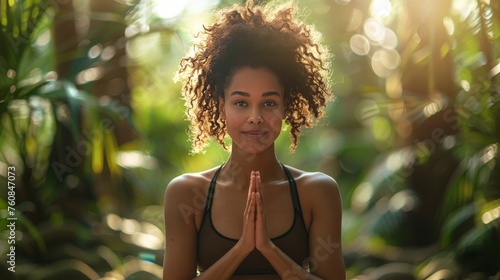 Woman Sitting in Yoga Position in Forest