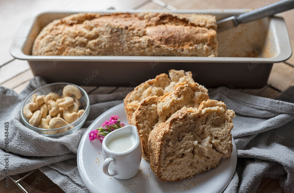 Slices of cake with crumble on a plate with fresh pan of yeast pastry and hot milk for breakfast. Homemade baking food. Close up. Slices of cake with crumble on a plate with fresh pan of yeast pastry and hot milk for breakfast. Homemade baking food. Close up.