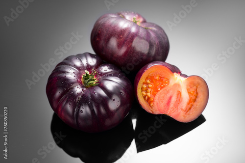 Black tomato, fresh ripe natural bio tomatoes close-up. Tasty organic Black Beauty tomato on black background. Close up. Garden, Gardening concept