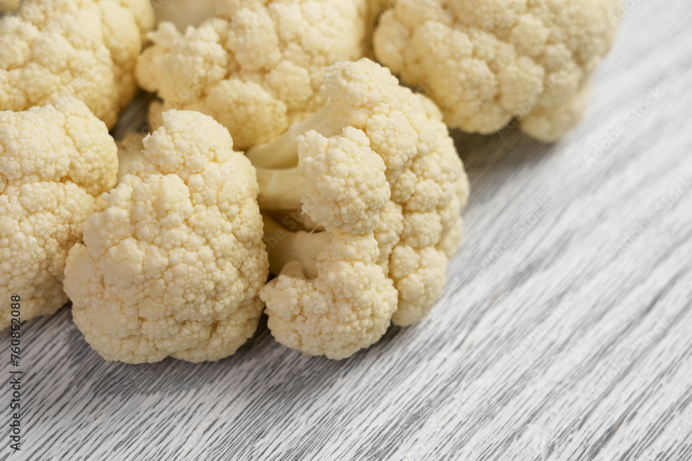 Fresh cauliflower on a wooden kitchen cutting board. Raw vegetable dietary ingredients Fresh cauliflower on a wooden kitchen cutting board. Raw vegetable dietary ingredients