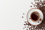 Flat lay of cup of coffee and coffee beans on white background