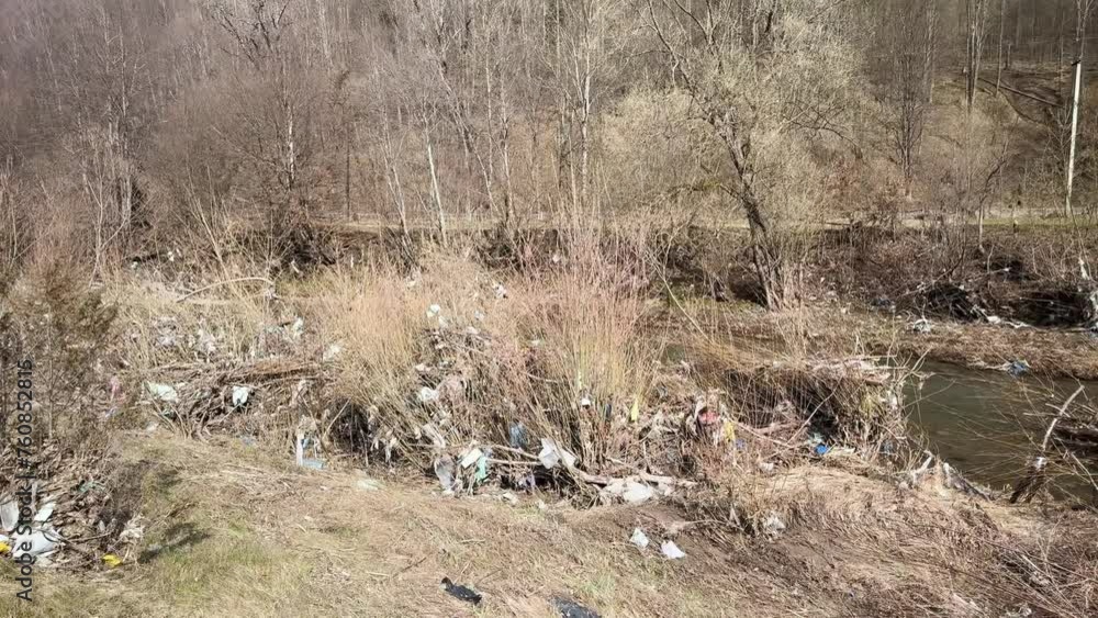 uncultured people throw garbage into the river, fast water carries polyethylene and other non-degradable waste of civilization into large rivers, littering their banks with plastic. uncultured people throw garbage into the river, fast water carries polyethylene and other non-degradable waste of civilization into large rivers, littering their banks with plastic.