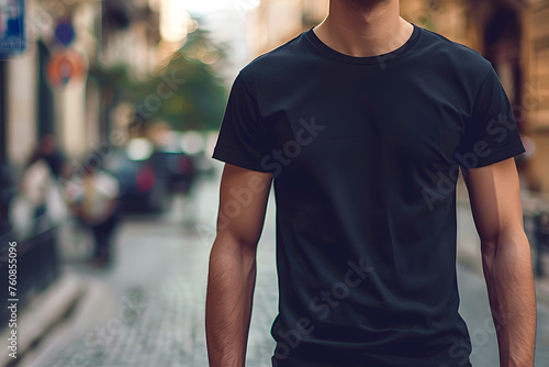 Young man in black tshirt walking on the street in the city. Mockup tshirt