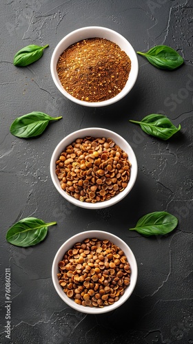 Various types of grains and cereals in white cups on a dark background with green basil leaves. Concept: healthy eating and culinary blogs, articles about veganism and vegetarianism