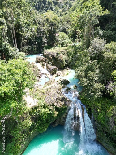 Multi-tier Kawasan falls with waterfall Blue lagoons amid tropical jungle. Aerial photo