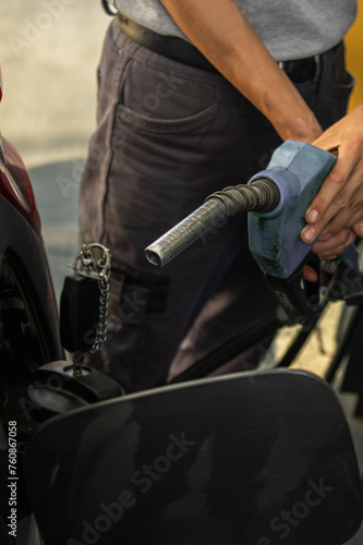 fuel pump filling gasoline or gasoline in vehicle with rising prices according to the economy
