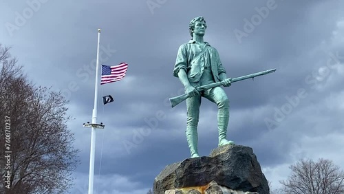 The famous Minuteman Statue of the Revolutionary War minuteman stands tall on Lexington Green Battle. It is here the Revolutionary War started on April 19, 1775. photo