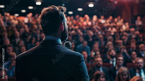 Motivational speaker with headset performing on stage photo