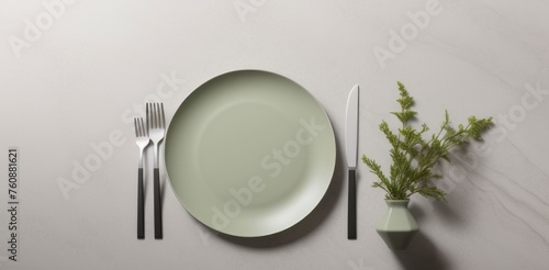 Minimalistic table setting in neutral green color on gray concrete background, perfect for modern kitchens and Scandinavian-style tableware. Suitable for business food brand photo