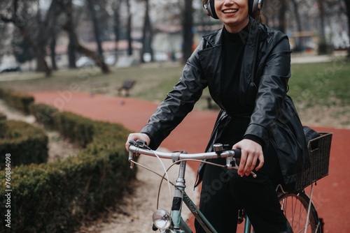 Confident and attractive young woman with a stylish look enjoys a leisurely bike ride, embodying elegance and freedom.