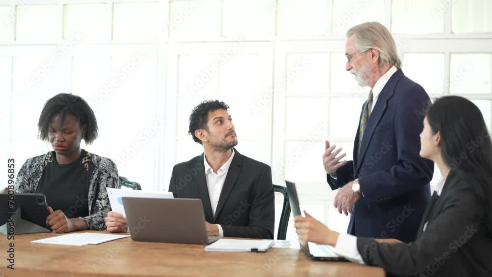 Corporate business team and manager in meeting. Diversity of business people of African and Latin women and Caucasian men are working together. Senior boss are consulting team at clean interior room. Corporate business team and manager in meeting. Diversity of business people of African and Latin women and Caucasian men are working together. Senior boss are consulting team at clean interior room.