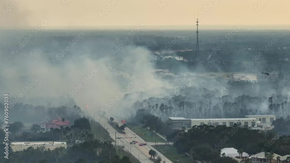 Aerial view of strong wildfire burning severely in North Port city, Florida. Natural disaster during dry season in jungle woods Aerial view of strong wildfire burning severely in North Port city, Florida. Natural disaster during dry season in jungle woods
