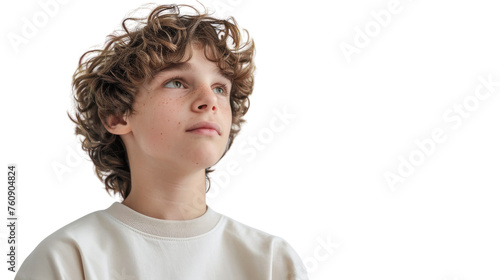 A young boy with curly hair wearing a white shirt gazes into the distance with a thoughtful expression