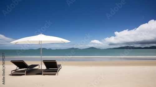 Two Lounge Chairs Under Umbrella at Beach © we360designs