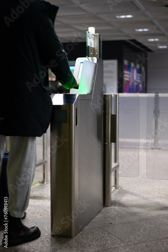 A passenger checks in at a self service entrance control of an airport