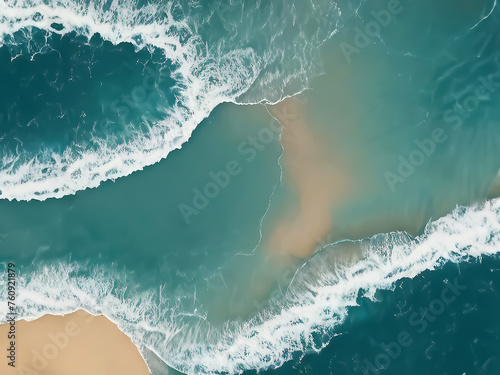 Ocean waves. Azure sea surface with a strip of sandy beach. View from above