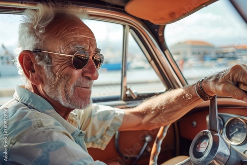 old man driving a vintage car