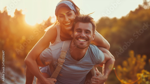 With a cheerful smile, the man carries the radiant woman on his back, both of them savoring the delightful moment of a playful piggyback ride as a young couple.