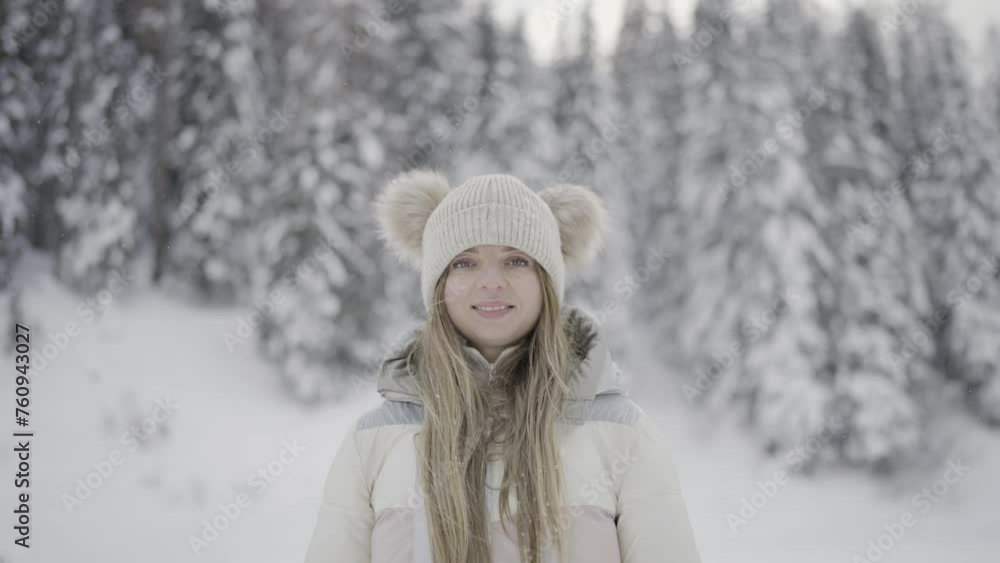 Woman smiles in front of trees with snow Woman smiles in front of trees with snow