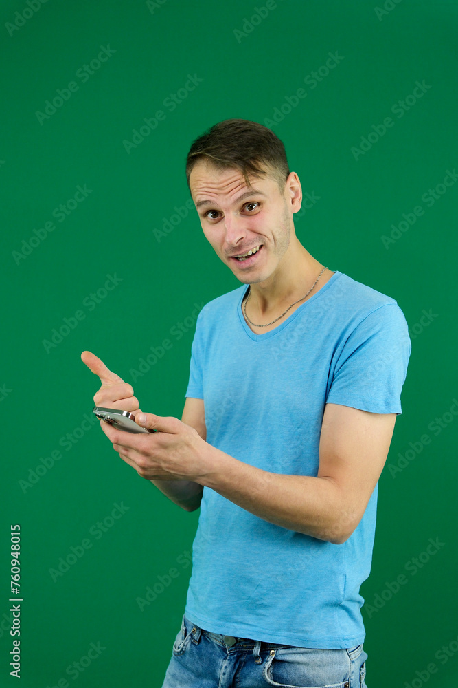 Young promoter man wear shirt white t-shirt point index finger camera on you indicate index finger aside on workspace area copy space mock up isolated on plain pastel green background studio Young promoter man wear shirt white t-shirt point index finger camera on you indicate index finger aside on workspace area copy space mock up isolated on plain pastel green background studio