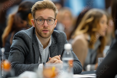 Focused young businessman in conference meeting, symbolizing strategic thinking and professional engagement concept photo