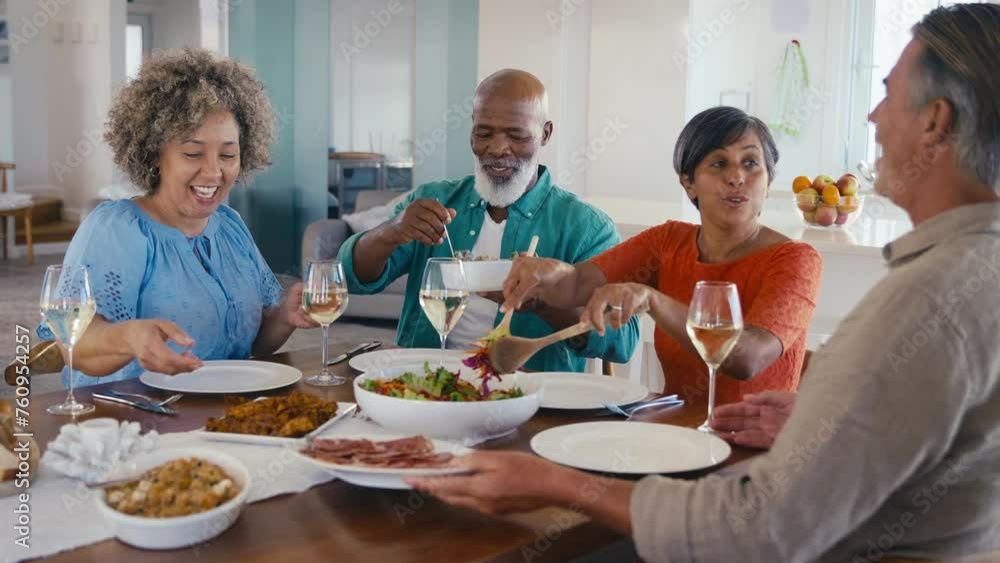 Group of mature friends at home relaxing meeting for lunch with wine - shot in slow motion Group of mature friends at home relaxing meeting for lunch with wine - shot in slow motion