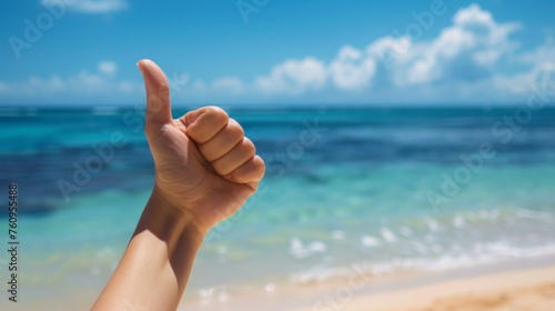Thumbs up sign. Woman's hand shows like gesture. Beach background