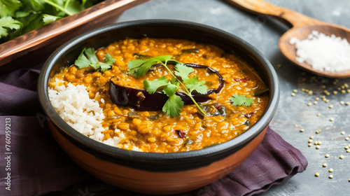 dal daal brinjal curry jaggery gud and clarified butter or ghee . Generative Ai