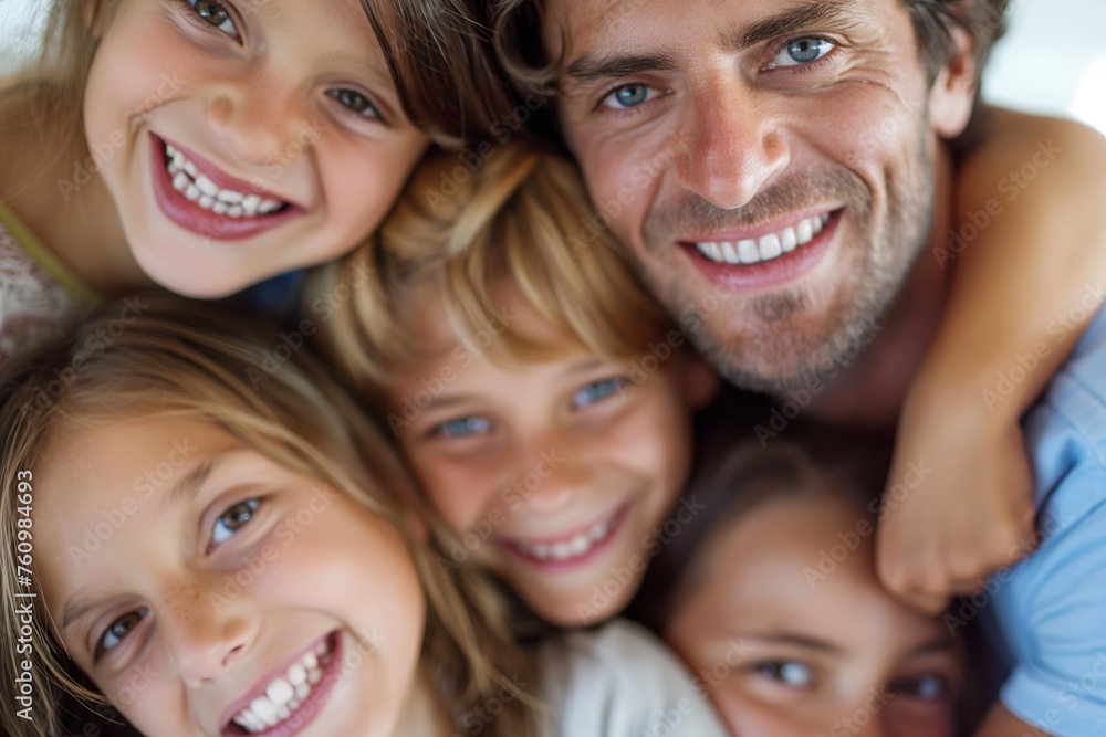 A joyful family moment, with a father and his children huddled together, smiling brightly, showcasing a strong bond and happiness. A joyful family moment, with a father and his children huddled together, smiling brightly, showcasing a strong bond and happiness.