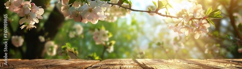 A Sun-kissed spring blossoms framing a rustic wooden tabletop with a vibrant green bokeh background.