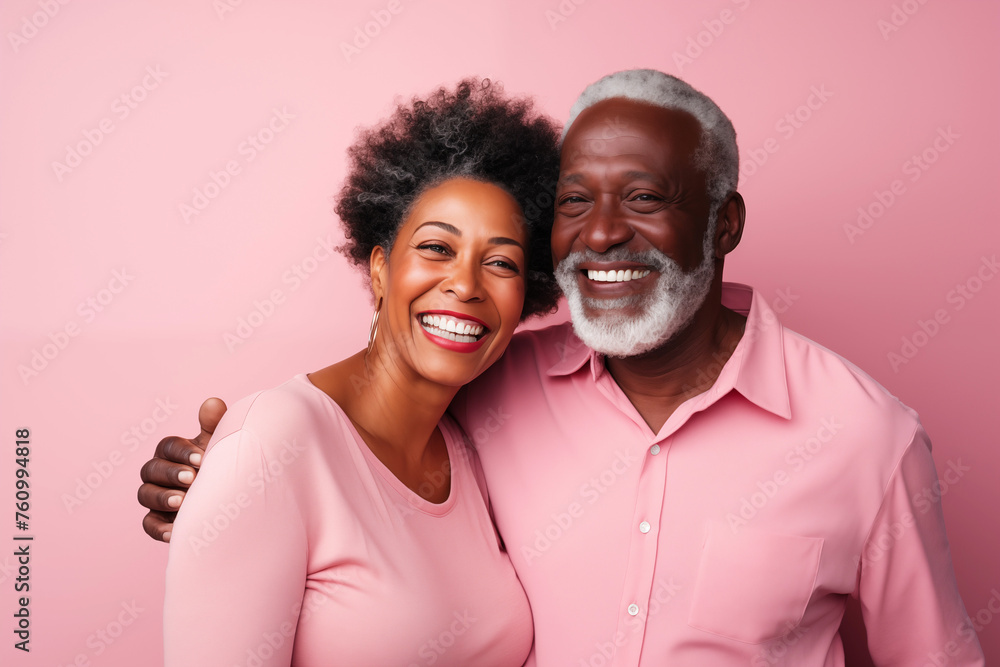 Obraz premium Close up studio portrait of handsome mature black couple against pink background.