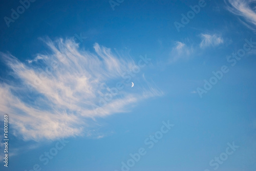 waxing moon among gentle cirrus clouds photo