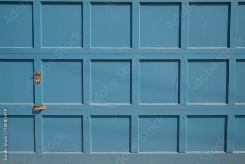Blue wooden garage door with panels