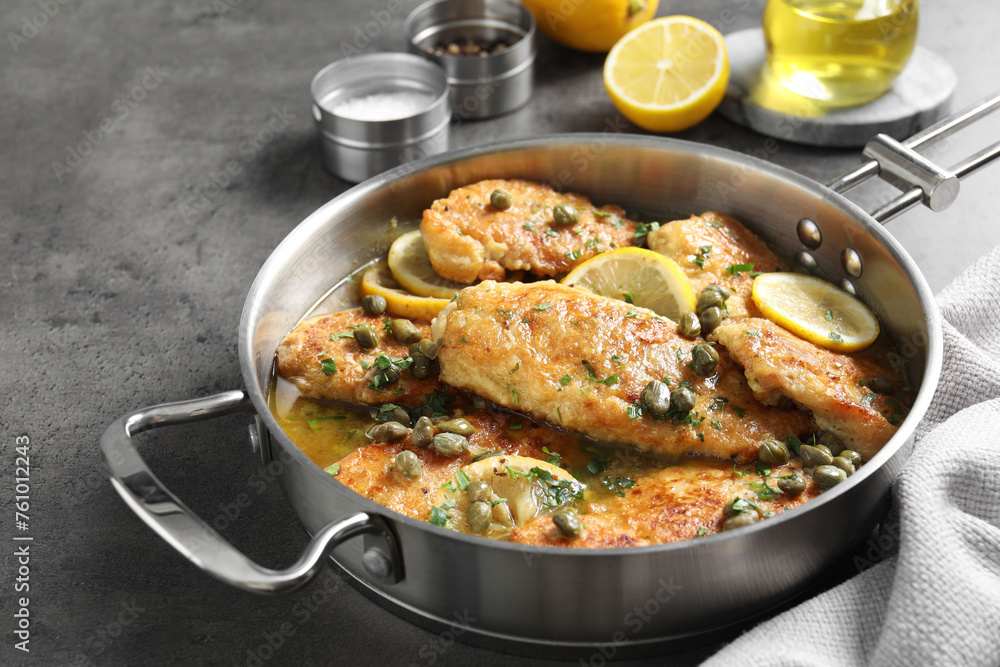 Delicious chicken piccata on grey table, closeup Delicious chicken piccata on grey table, closeup