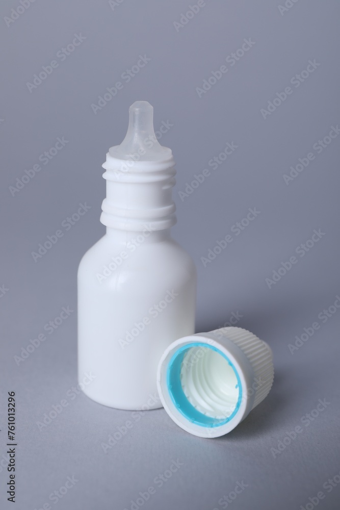 Bottle of medical drops on gray background Bottle of medical drops on gray background