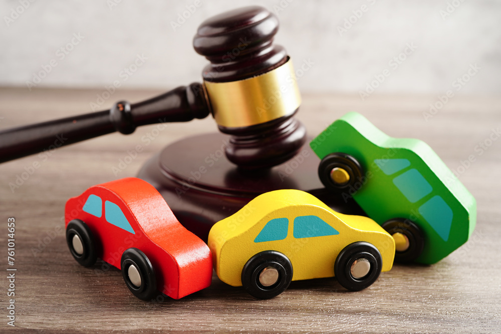 Car accident lawsuit and insurance, Judge hammer with car model.