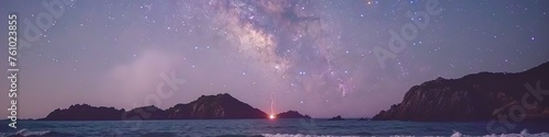 Panoramic view of the starry night sky with the Milky Way galaxy stretching over a tranquil sea landscape