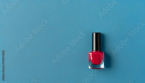 Red Nail polish in blue background. Manicure concept