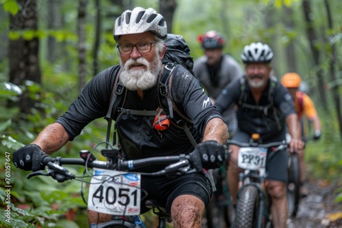 An elderly man mountain biking through the forest.
