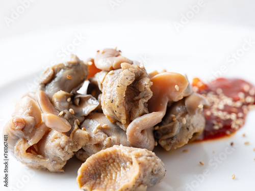 Boiled whelk with spicy sauce on a plate photo