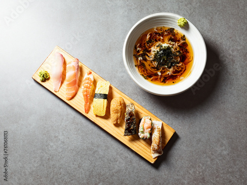 Variety of sushi and cold buckwheat noodles