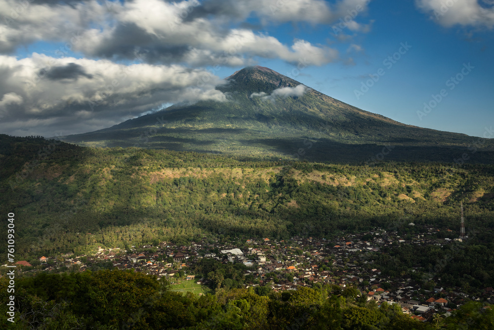 Famous Mount Agung volcano and Culik Village viewpoint during sunny day and blue sky in Amed, Karangasem, Bali, Indonesia