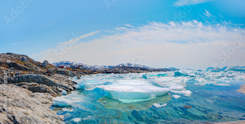 Melting of a iceberg and pouring water into the sea - Greenland - Tiniteqilaaq, Sermilik Fjord, East Greenland
