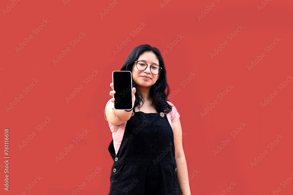 17 year old Latin teenage woman shows the cell phone screen with promotions and discounts 17 year old Latin teenage woman shows the cell phone screen with promotions and discounts