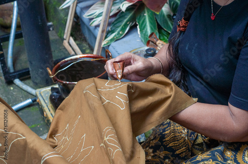 a woman is doing work on cloth photo