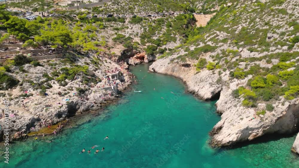 Drone view of the rocky coastline with people swimming in a clear water. Zakynthos, Greece. Drone view of the rocky coastline with people swimming in a clear water. Zakynthos, Greece.