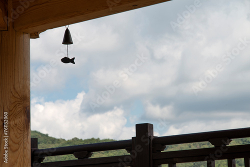 The bell hanging on the wooden pavilion with the sky background photo